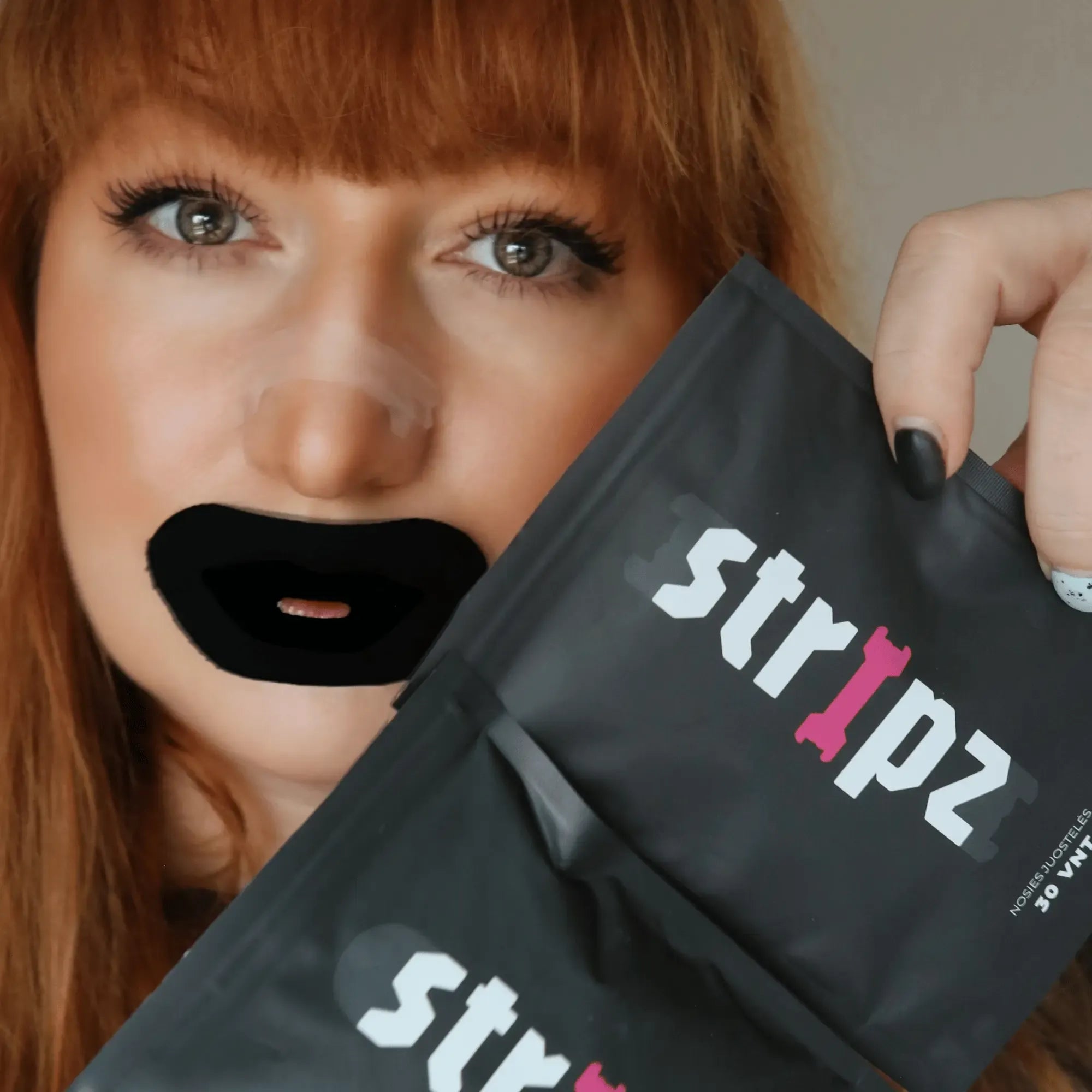 Person holding a 'stripz' product packaging