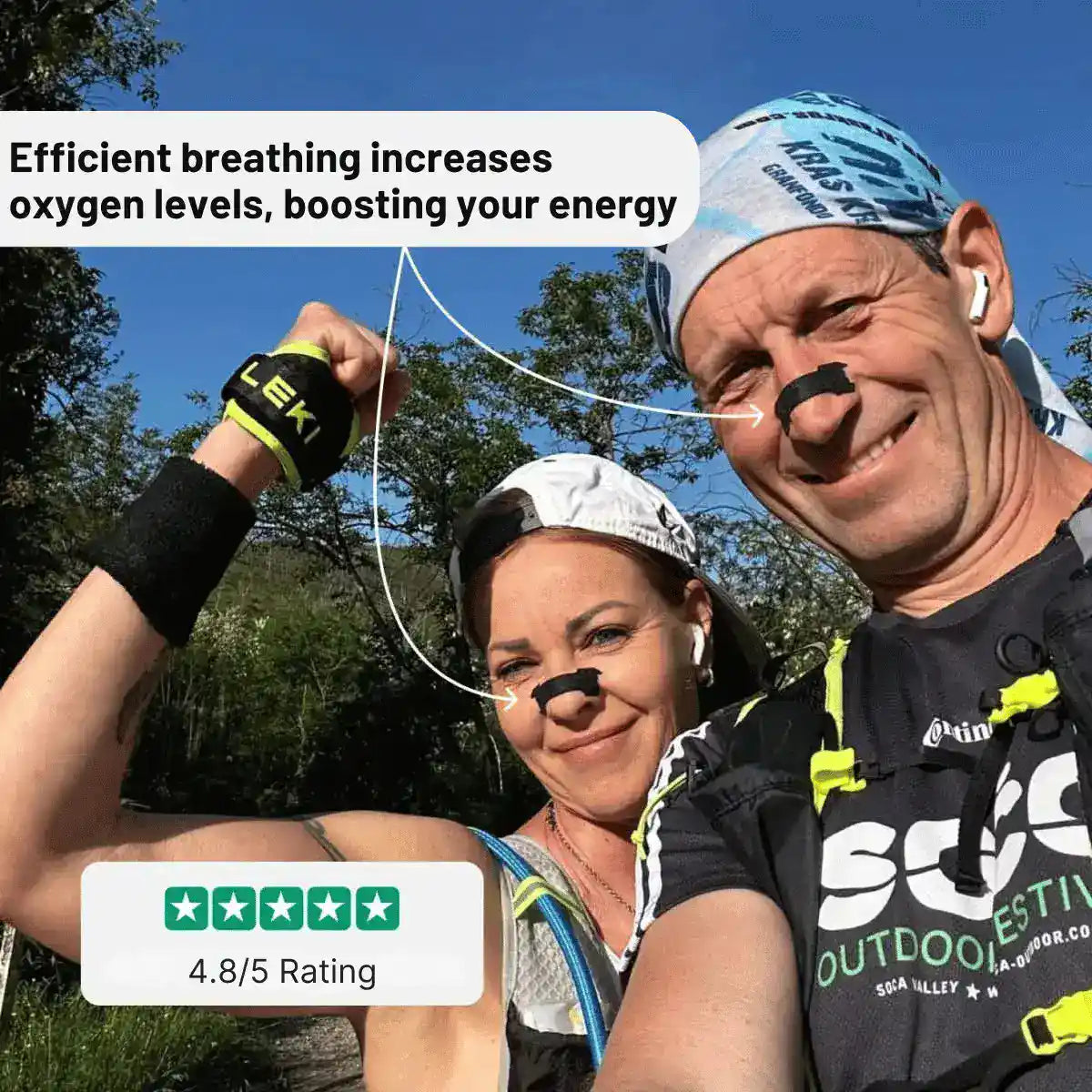 Two people outdoors with breathing devices, surrounded by nature.